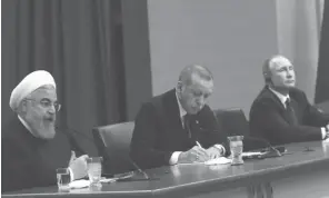  ??  ?? Le président iranien Hassan Rohani, le président turc Recep Tayyip Erdogan et le président russe Vladimir Poutine, le 04 avril 2018 à Ankara en Turquie