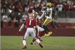  ?? JED JACOBSOHN — THE ASSOCIATED PRESS FILE ?? Green Bay Packers wide receiver Davante Adams, right, catches a pass against San Francisco 49ers middle linebacker Fred Warner, rear, and cornerback Jimmie Ward (1) during the second half in Santa Clara on Sept. 26.