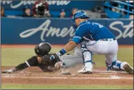  ?? THE CANADIAN PRESS/FRED THORNHILL ?? Chicago White Sox Yoan Moncada is out at the plate with the tag by Toronto Blue Jays catcher Luke Maile in the seventh inning of their American League MLB baseball game in Toronto on Tuesday.