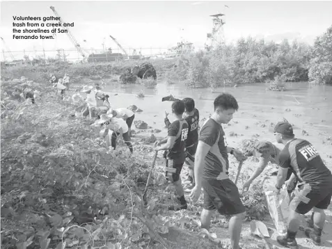  ??  ?? Volunteers gather trash from a creek and the shorelines of San Fernando town.