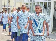  ?? Picture: FIJIAN DRUA ?? Evivi Senikarivi carries the Super W trophy as she leads her Rooster Chicken Fijian Drua W teammates at the State House in Suva yesterday.