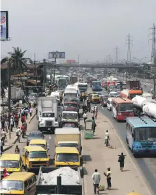  ??  ?? Traffic backed up in Lagos, Nigeria, where Guangzhou operates an assembly plant. On the production line at Foton, right, which hopes to recover from bankruptcy