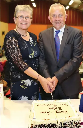  ??  ?? Ann and Henry Keogh, who recently retired from the local post office, cutting the cake at a party in their honour. The party was hosted by the local community in Rockchapel as a mark of appreciati­on for their many years of service.