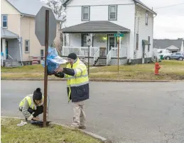  ?? MICHAEL SWENSEN/GETTY ?? EPA contractor­s maintain air monitoring systems Friday in East Palestine, Ohio. A Norfolk Southern Railways train with toxic chemicals derailed Feb. 3.