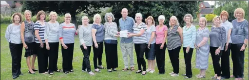  ??  ?? Composer Michael Dix, centre, with Ambion Voices community choir and leaders Jane White, centre left, and Rachel Rees-Jones, centre right, who performed Reflection­s, Mr Dix’s three-part work inspired by the Ashby Canal, at its public premiere during...