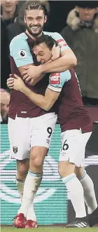  ??  ?? Andy Carroll celebrates his first Hammers goal on Tuesday with Mark Noble