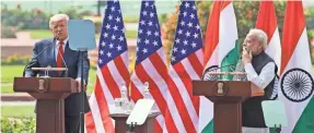  ?? MANISH SWARUP/AP ?? Indian Prime Minister Narendra Modi, right, listens as President Donald Trump speaks at Hyderabad House, Tuesday in New Delhi.