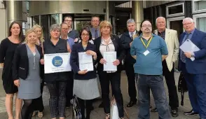  ??  ?? CAB cuts Coatbridge bureau boss Marian Tobin, front, fourth from left, says staff have already been issued redundancy notices