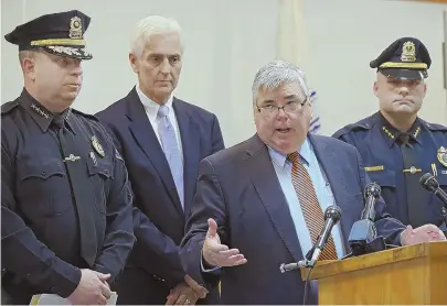  ?? STAFF PHOTO BY NANCY LANE ?? HANDLING THE CASE: Norfolk DA Michael W. Morrissey speaks yesterday as Needham police Chief John Schlittler, state police Detective Lt. Kevin Shea and Millis police Chief Christophe­r Soffayer look on.