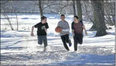  ??  ?? John Smith (Marcel Ruiz, with ball) miraculous­ly survives being trapped beneath the ice in a frigid lake in the faith-based drama Breakthrou­gh.