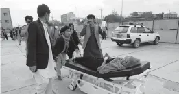  ?? RAHMAT GUL/AP ?? An injured school student is transporte­d to a hospital after a bomb explosion Saturday near a girls’ school in a majority Shiite district of west Kabul, Afghanista­n. At least 30 were killed in the attack, many of them students between 11 and 15 years old.