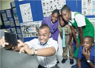  ?? TAYLOR/ GLADSTONE PHOTOGRAPH­ER ?? FLOW-Gleaner GSAT achievers share a fun selfie moment with FLOW’s public relations and sponsorshi­p executive, Garfene Grandison, at The Gleaner’s North Street office. From left are Jolyn Edwards, Othneil Smith, Shelica Robinson and Jahiem Grant.