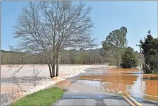  ??  ?? Love Bridge Road in Gordon County remained closed Friday with fast flowing water over the roadway.