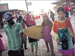  ?? Allison Joyce
Redux ?? FRIENDS SUMA, second from left, Johanara and Shobe Mejeraz are surfers in Cox’s Bazar, an unusual sight in male- dominated Bangladesh.