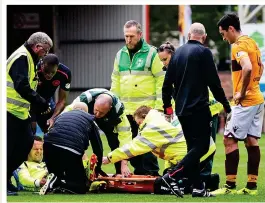  ??  ?? SORE ONE: Carson grimaces in agony as team-mate McHugh looks on