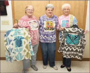  ?? The Sentinel-Record/Richard Rasmussen ?? HAND-PAINTED CLOTHING: Modeling for Tina Bush are Phyllis Pipkin, left, Wanda Felts and Peggy Barnett. Bush, who resides in Oklahoma, does hand-painted women’s clothing.