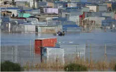  ?? African News Agency (ANA) ?? SHACKS built near the Diep Rivier in Dunoon were flooded after heavy rainfall at the weekend. The SA Weather Service has warned of more severe weather to hit the province. | HENK KRUGER