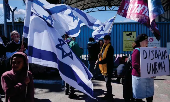  ?? Photograph: Ohad Zwigenberg/AP ?? Israelis protesting outside the entrance to Unrwa’s offices in Jerusalem on 20 March 2024. Israel has claimed that members of Unrwa are affiliated with Hamas and Islamic Jihad.