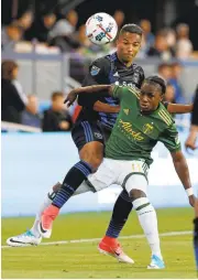  ?? JIM GENSHEIMER/STAFF ?? Earthquake­s forward Danny Hoesen, left, passes the ball as the Timbers’ Darren Mattocks defends in the first half.