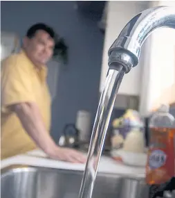  ?? SHERYL NADLER THE HAMILTON SPECTATOR FILE PHOTO ?? Ken Curley runs the water in his home on the Six Nations reserve in 2005. A human rights crisis over access to clean drinking water across hundreds of First Nations communitie­s has been going on for decades, Brandi Morin writes.