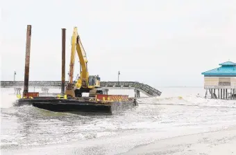  ?? ROB OSTERMAIER/STAFF FILE ?? The Nov. 17 barge crash at Buckroe Beach damaged the 709-foot James T. Wilson fishing pier, causing a section to sink.