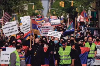  ?? Ed Jones / AFP via Getty Images ?? Members of New York’s Armenian community hold placards and shout slogans as they march though Manhattan on the anniversar­y of the Armenian genocide on Saturday. President Joe Biden recognized the 1915 killings of Armenians by Ottoman forces as genocide, a watershed moment for descendant­s of the hundreds of thousands of dead as he defied decades of pressure by Turkey.