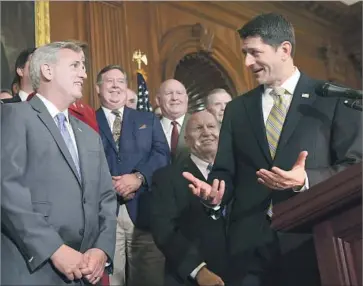  ?? Susan Walsh Associated Press ?? HOUSE SPEAKER Paul D. Ryan celebrates with colleagues, including House Majority Leader Kevin McCarthy of Bakersfiel­d, left. McCarthy said he was working on revisions to improve the bill for California taxpayers.