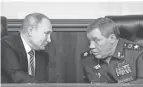  ?? SERGEI GUNEYEV/SPUTNIK VIA AP ?? Russian President Vladimir Putin, left, and Russian General Staff head Valery Gerasimov talk Tuesday in Moscow.