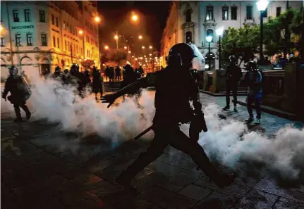  ?? Martin Mejia/Associated Press ?? Police try to break up a protest by supporters of ousted President Pedro Castillo at Plaza San Martin in Lima, Peru, Sunday.