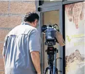  ?? RICK BOWMER/AP ?? A TV cameraman films the entrance of Scales and Tails Utah, Aug. 16 in West Valley City, Utah. A Utah reptile center employee is recovering after an alligator yanked her into its enclosure during a presentati­on, and a visitor leapt in after her and freed her from its jaws.