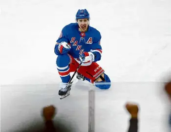  ?? John Munson/Associated Press ?? Rangers forward Artemi Panarin celebrates his tying goal during the third period against the Islanders on Saturday in New York.