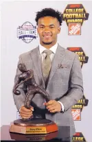  ?? JOHN BAZEMORE/ASSOCIATED PRESS ?? Oklahoma quarterbac­k Kyler Murray poses with the trophy after winning the Davey O’Brien Award Thursday.