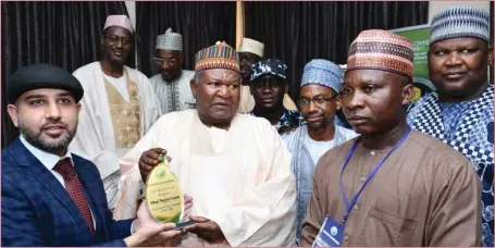  ??  ?? Lawal (middle) receiving 2019 Amirul Hajj Best Award from officials of Independen­t Hajj Reporters