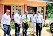  ??  ?? Browns officials planting a tree at Thodamaduw­a Vidyalaya premises