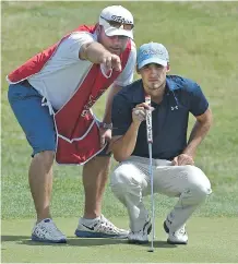  ?? ED KAISER/ EDMONTON JOURNAL ?? Brett Hogan of the Willow Park Golf Course gets some advice on the 18th green from his caddy ( and father), Brian Hogan, during play on Monday at the Alberta Amateur Golf Tournament.