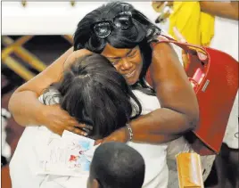  ?? Darron Cummings ?? The Associated Press Tia Coleman is comforted by a guest Friday during a funeral for her husband, Glenn, and children Reece, Evan and Arya, in Indianapol­is. Nine members of the Coleman family were killed in a duck boat accident at Table Rock Lake near Branson, Mo.