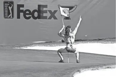  ?? ROB SCHUMACHER/THE REPUBLIC ?? A man runs onto the 16th green, delaying the tee shot of Stewart Cink during the second round of the WM Phoenix Open at TPC Scottsdale.