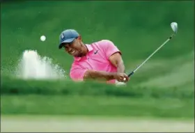  ?? MIKE CARLSON — THE ASSOCIATED PRESS ?? Tiger Woods hits from the bunker on the first hole during the third round of the Valspar Championsh­ip golf tournament Saturday in Palm Harbor, Fla.