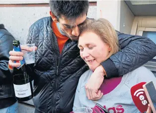  ?? Pictures: REUTERS, AFP/GETTY,ADY KERRY/CAMELOT/PA ?? Elena, who is unemployed, celebrates her lucky lottery win with a friend