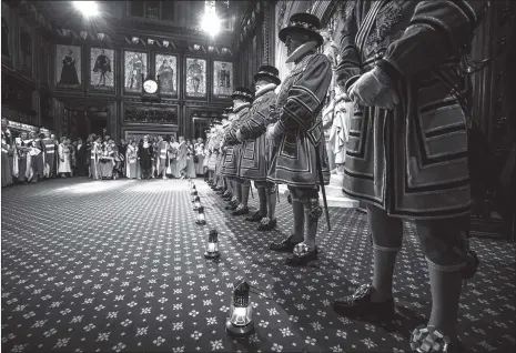  ??  ?? Yeoman warders take part in the ceremonial search in the peers lobby which is the traditiona­l start to the annual state opening of parliament in London on Wednesday.