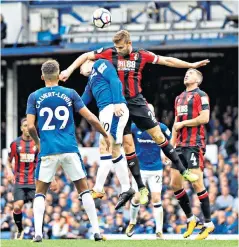  ??  ?? Aerial skirmish: Simon Francis catches Everton’s Wayne Rooney with his elbow