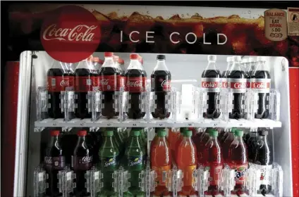  ??  ?? In this June 28, file photo, a Coca-Cola vending machine sits in the basement of the state Capitol as lawmakers debate a ban on local soda taxes, in Sacramento. Lawmakers passed the bill and Gov. Jerry Brown signed it into law, banning local soda taxes...