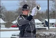  ?? PHOTOS BY MITCH HOTTS — THE MACOMB DAILY ?? Officer Nicholas Wagner, a member of the Clinton Township Police Honor Guard, performs “Taps” on the bugle during Friday’s ceremony for the late Police Chief Fred Posavetz.