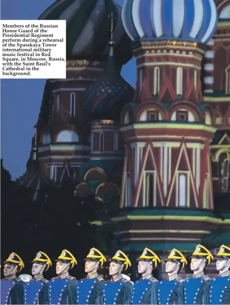 ??  ?? Members of the Russian Honor Guard of the Presidenti­al Regiment perform during a rehearsal of the Spasskaya Tower internatio­nal military music festival in Red Square, in Moscow, Russia, with the Saint Basil's Cathedral in the background.