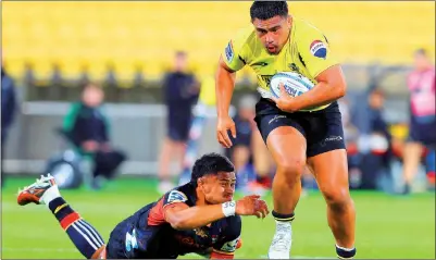  ?? PHOTO: AFP ?? The Wellington Hurricanes’ Xavier Numia sprints past the Waikato Chiefs’ Tupou Vaa’i during their Super Rugby match at Sky Stadium in Wellington, New Zealand, yesterday.