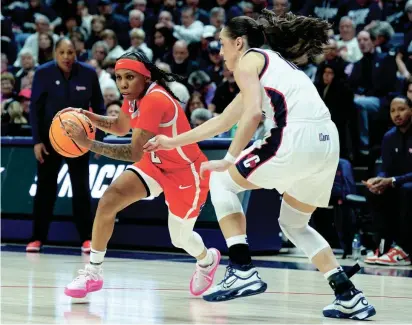  ?? DAVID BUTLER II/USA TODAY SPORTS ?? Syracuse guard Dyaisha Fair drives against UConn guard Nika Muhl during the second half on Monday.