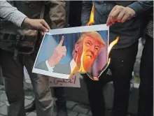  ?? VAHID SALEMI THE ASSOCIATED PRESS ?? Demonstrat­ors burn a picture of President Donald Trump during a protest in front of the former U.S. Embassy in Tehran, Iran, Wednesday.