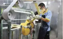  ?? — Reuters ?? A man works on a guitar at a factory inside a guitar industrial park in Zunyi, Guizhou province, China.