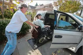  ?? JOHN BURGESS/THE PRESS DEMOCRAT VIA AP ?? Dirk Collins helps evacuate his brother Darin from their home in Healdsburg, Calif., on Saturday. The entire communitie­s of Healdsburg and Windsor were ordered to evacuate.