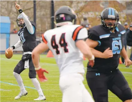  ?? KARL MERTON FERRON/BALTIMORE SUN ?? Protected by lineman Frank Petracco (61), Johns Hopkins quarterbac­k David Tammaro points before releasing a pass. Tammaro, who credited his offensive line, threw for 284 yards and a touchdown and ran for an additional 81 yards and a score.